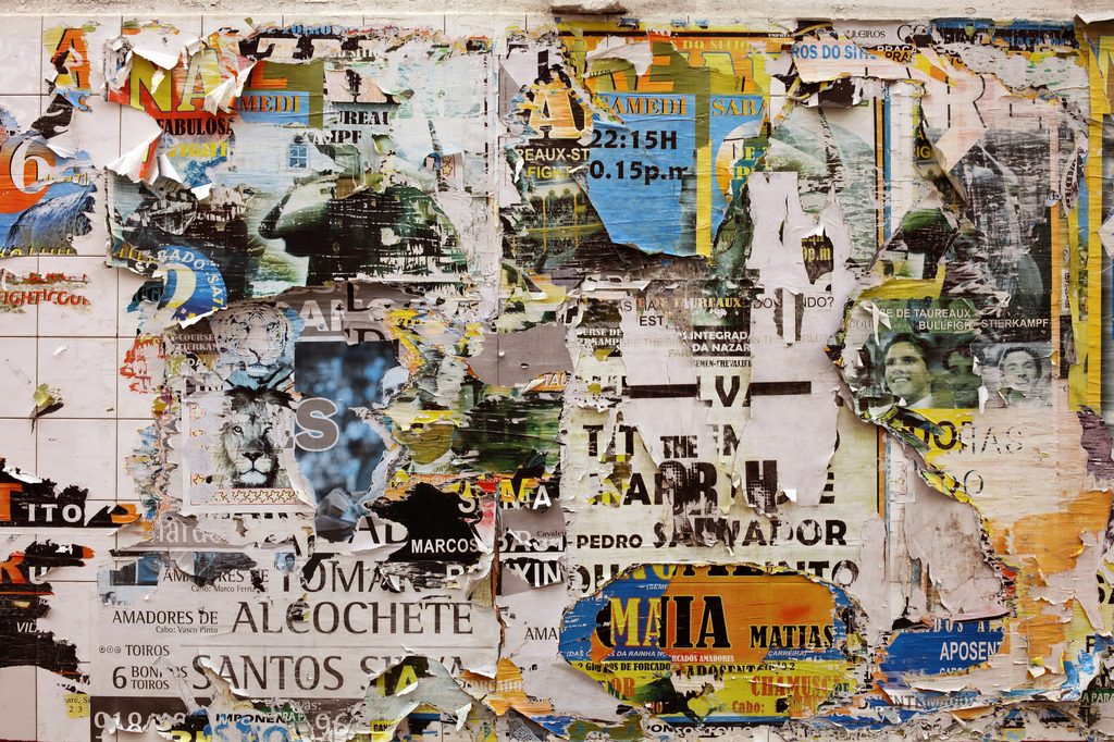 Wall layered with torn posters