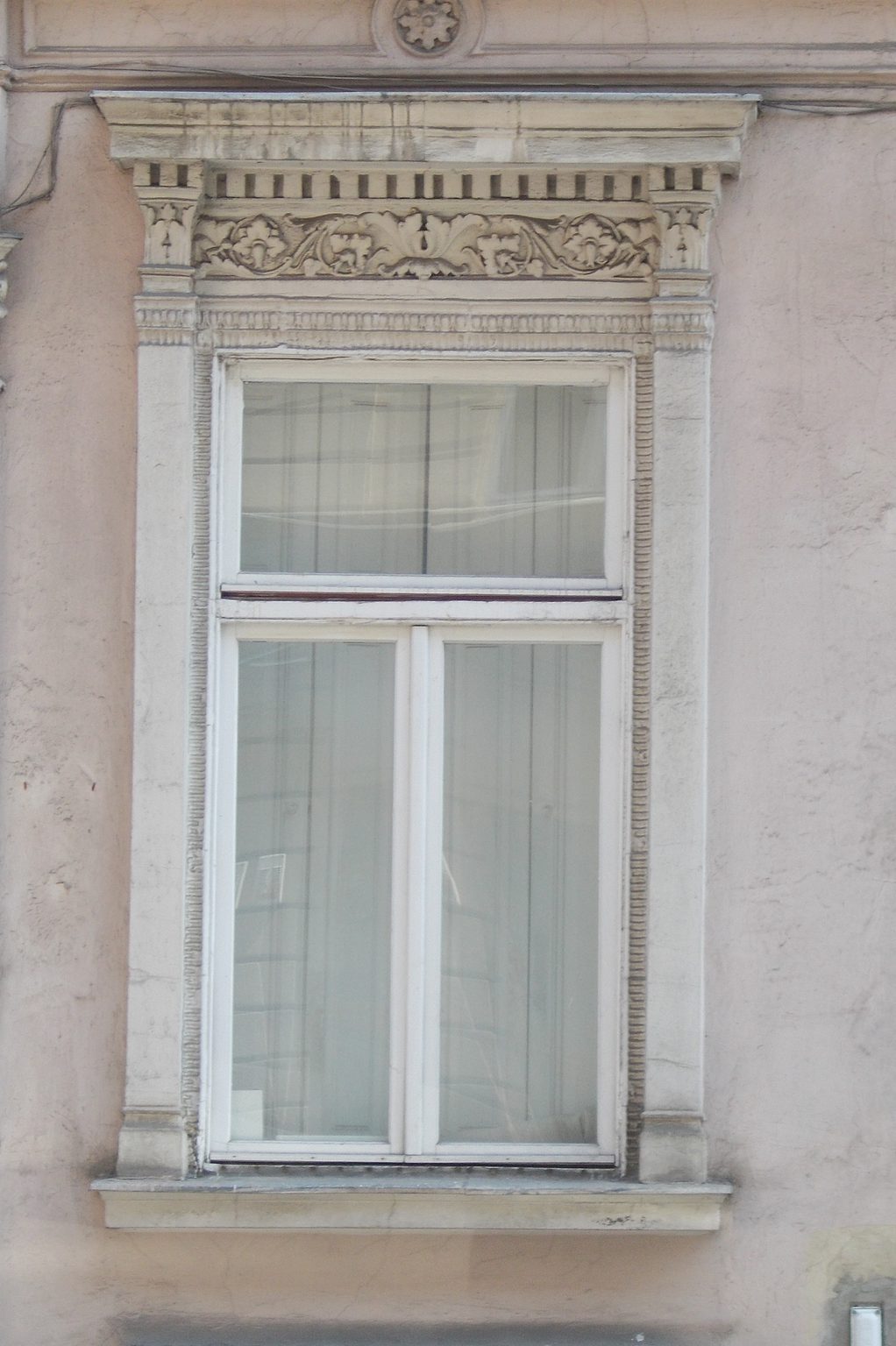 Window on a plain stucco facade