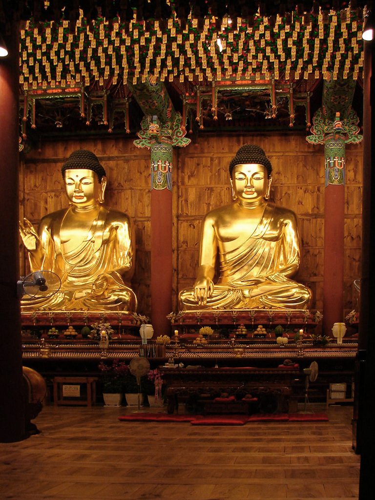 Gilded Buddha statues in a temple hall
