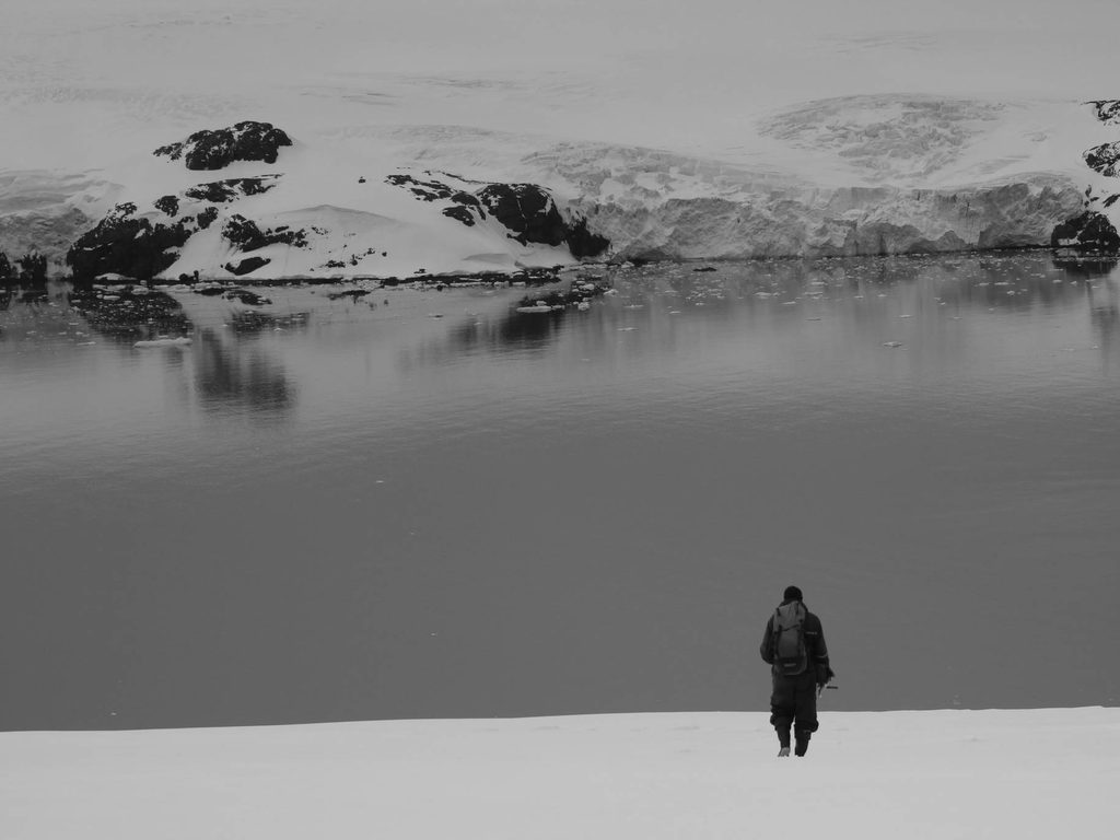 Lone figure crossing a glacier